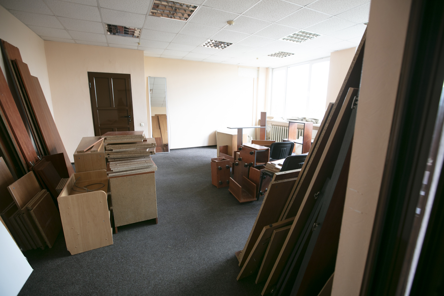 scattered office furniture in an empty room.